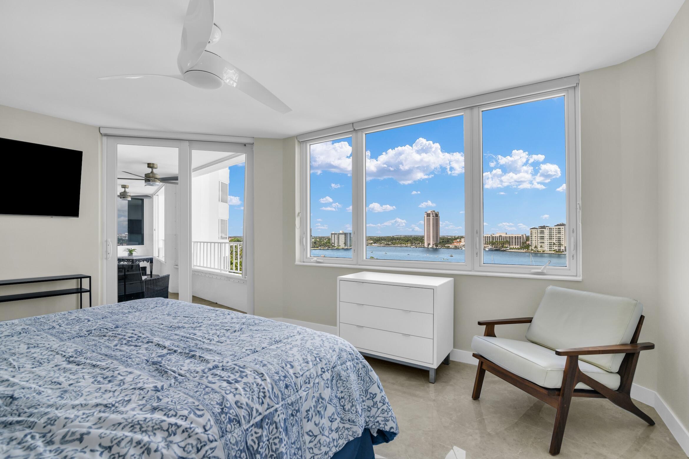 500 South Ocean Boulevard, Unit 1009 Boca Raton, FL 33432 - Photo 18 of 57 a bedroom with a bed and a large window with outer view