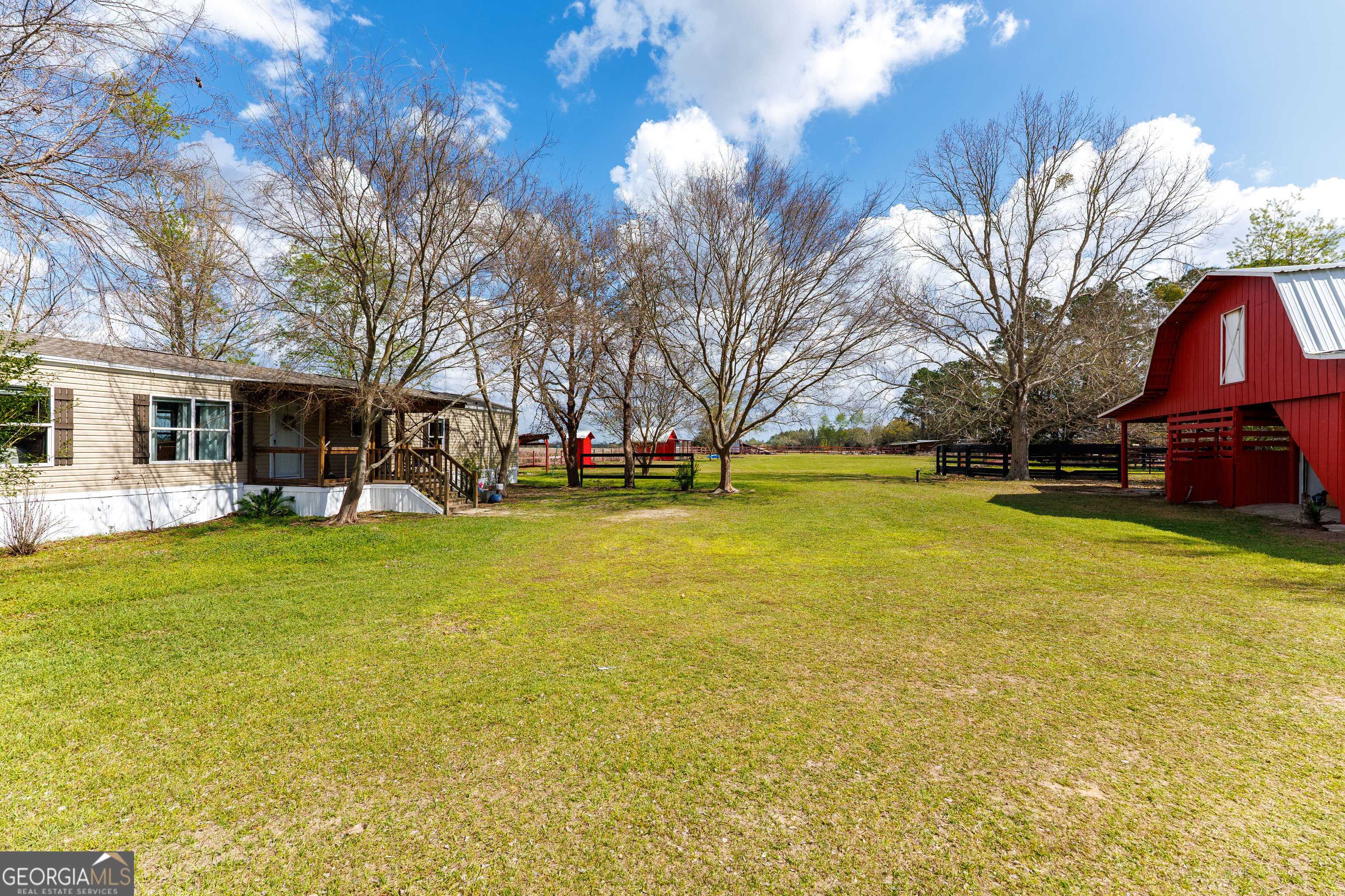1121 Futch Road Adel, GA 31620 - Photo 1 of 28 a view of a swimming pool with a bench and trees around