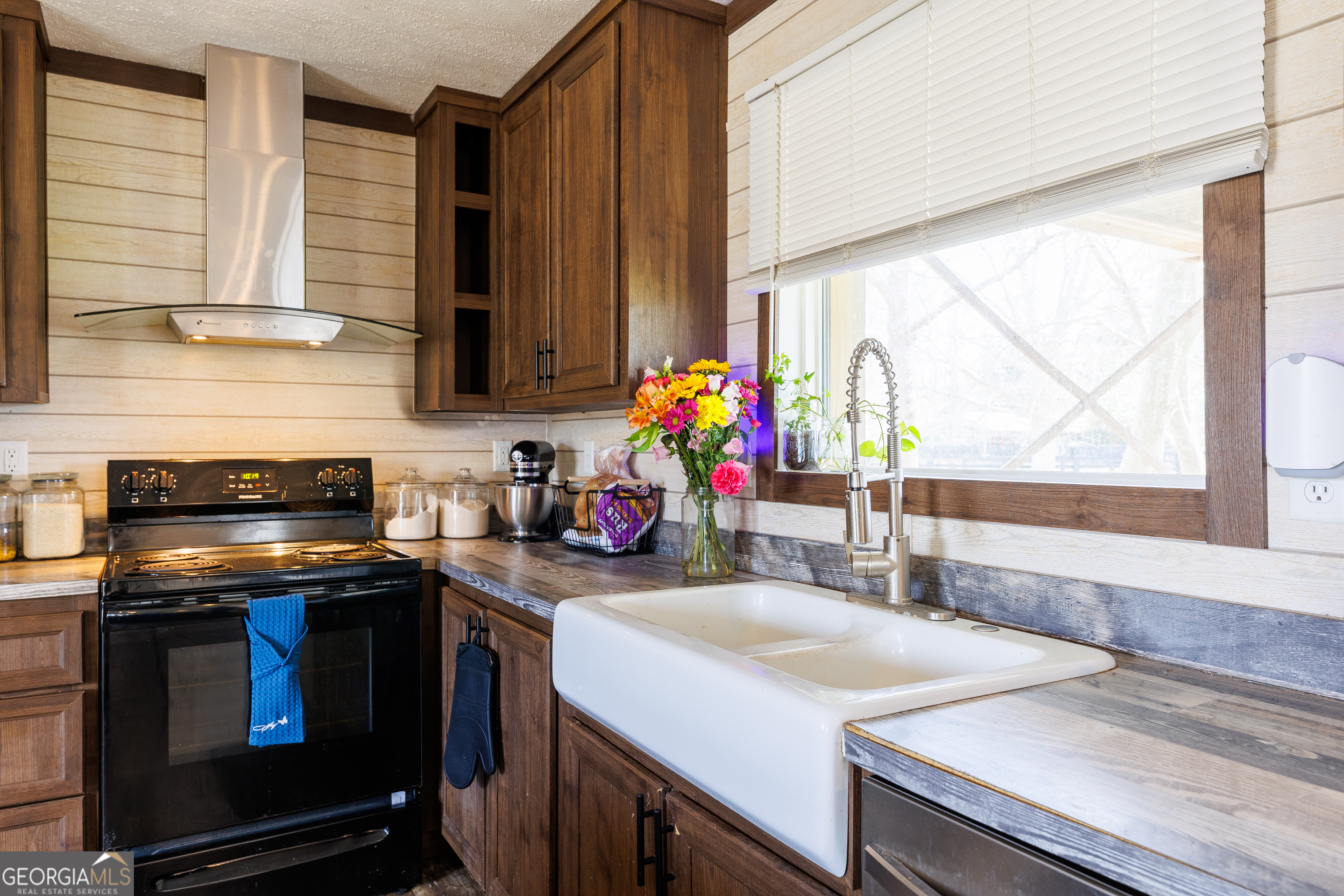 1121 Futch Road Adel, GA 31620 - Photo 12 of 28 a kitchen with a stove a sink and a microwave