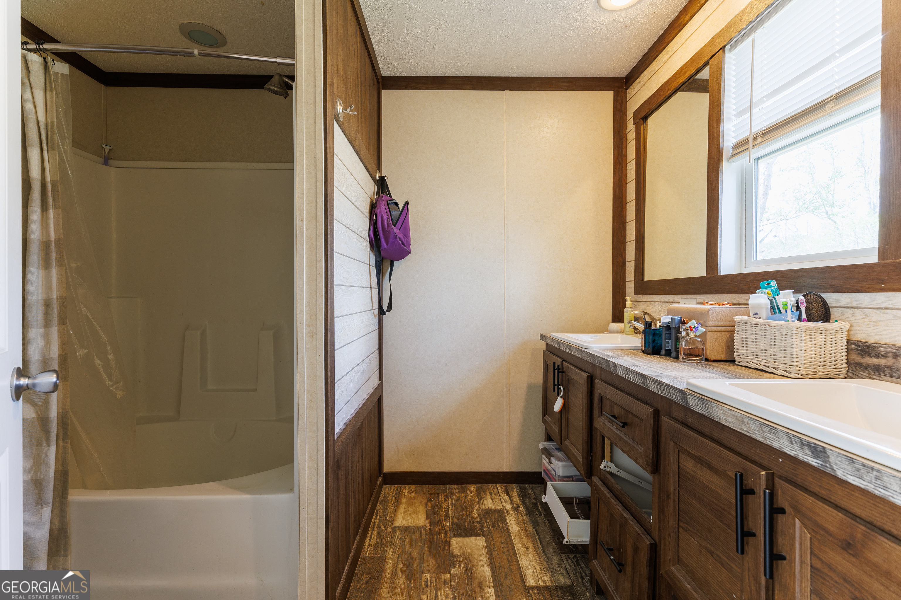 1121 Futch Road Adel, GA 31620 - Photo 15 of 28 a bathroom with a granite countertop sink a mirror and shower
