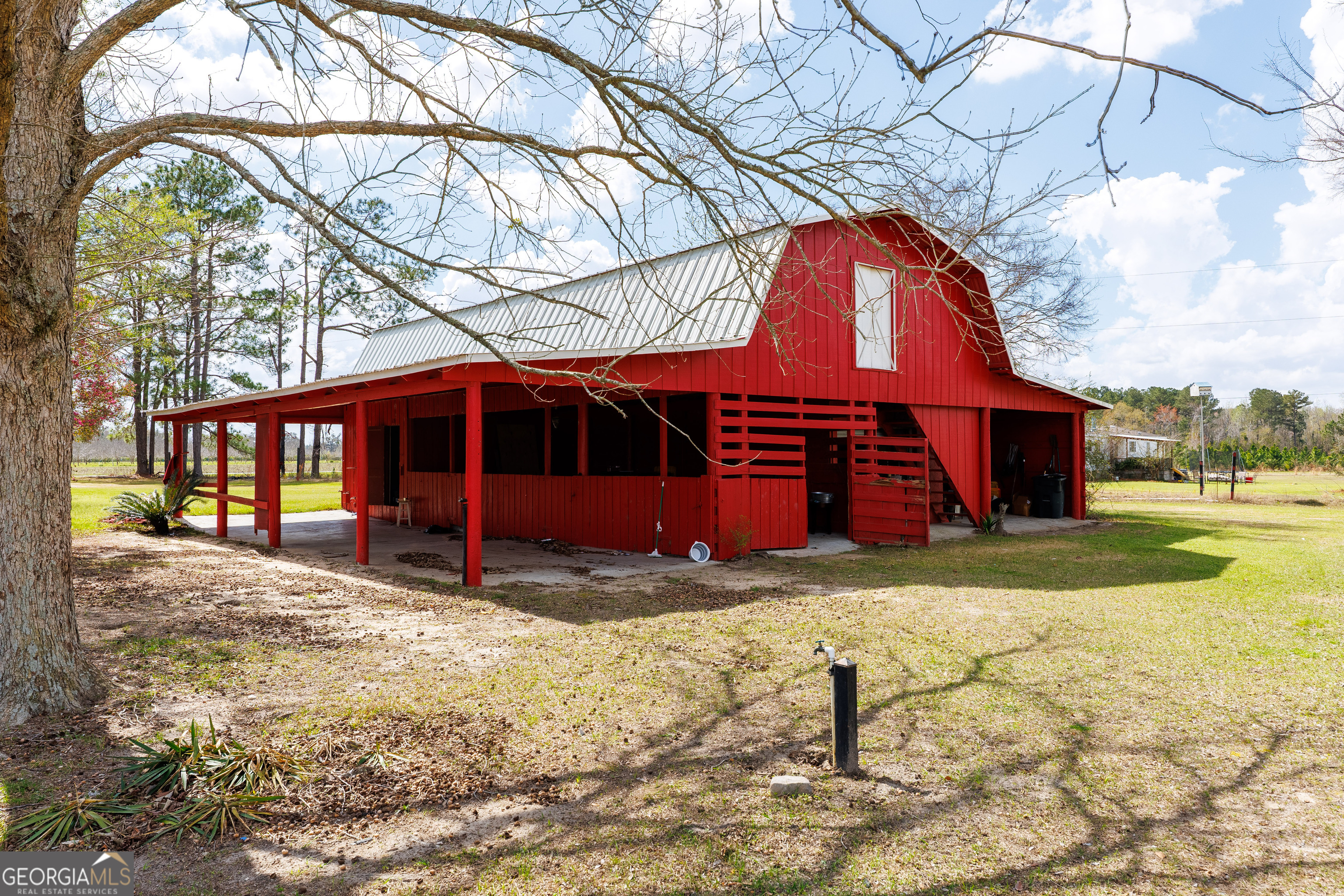 1121 Futch Road Adel, GA 31620 - Photo 22 of 28 a view of a yard in front of a house with a large tree
