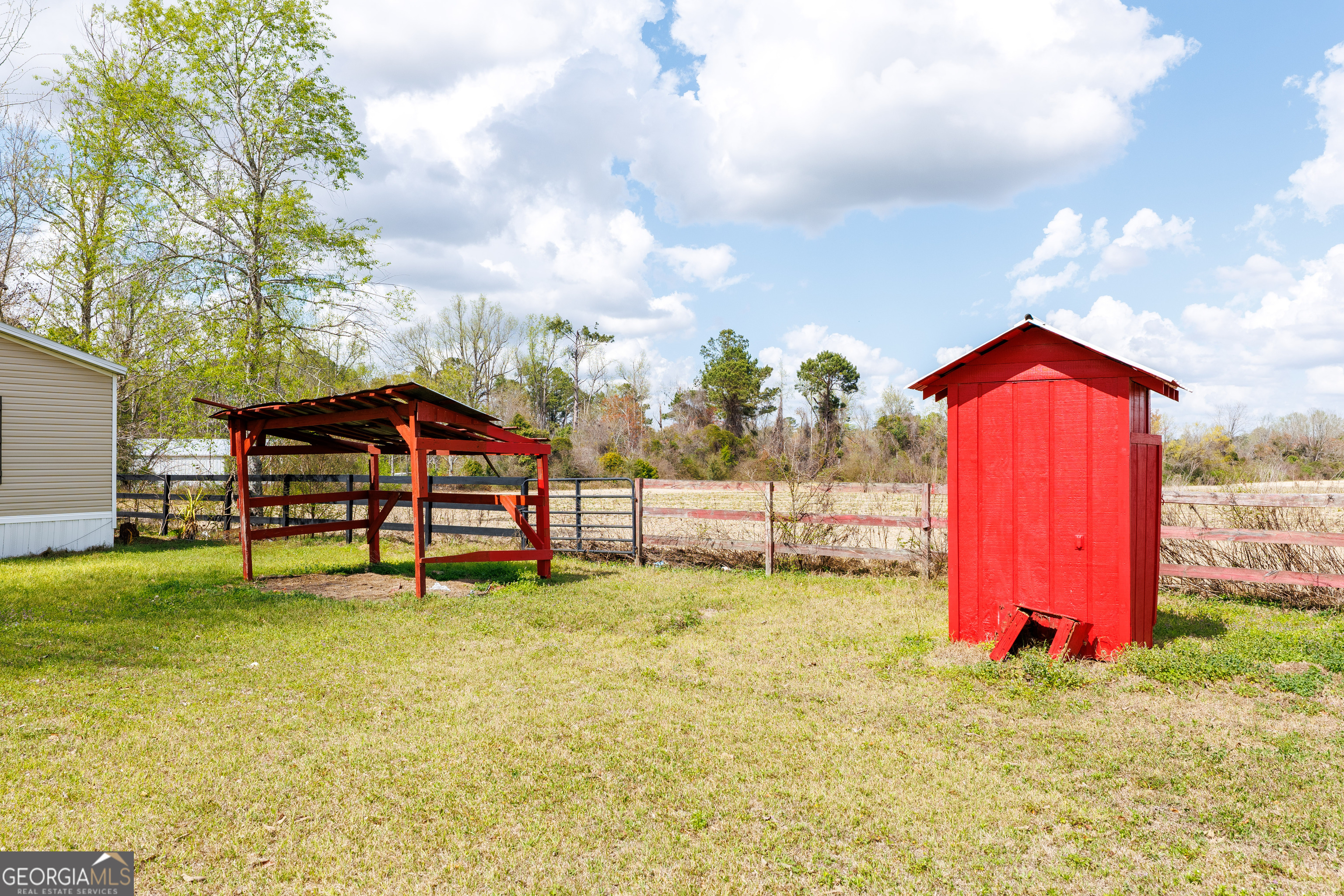 1121 Futch Road Adel, GA 31620 - Photo 28 of 28 a backyard of a house with table and chairs