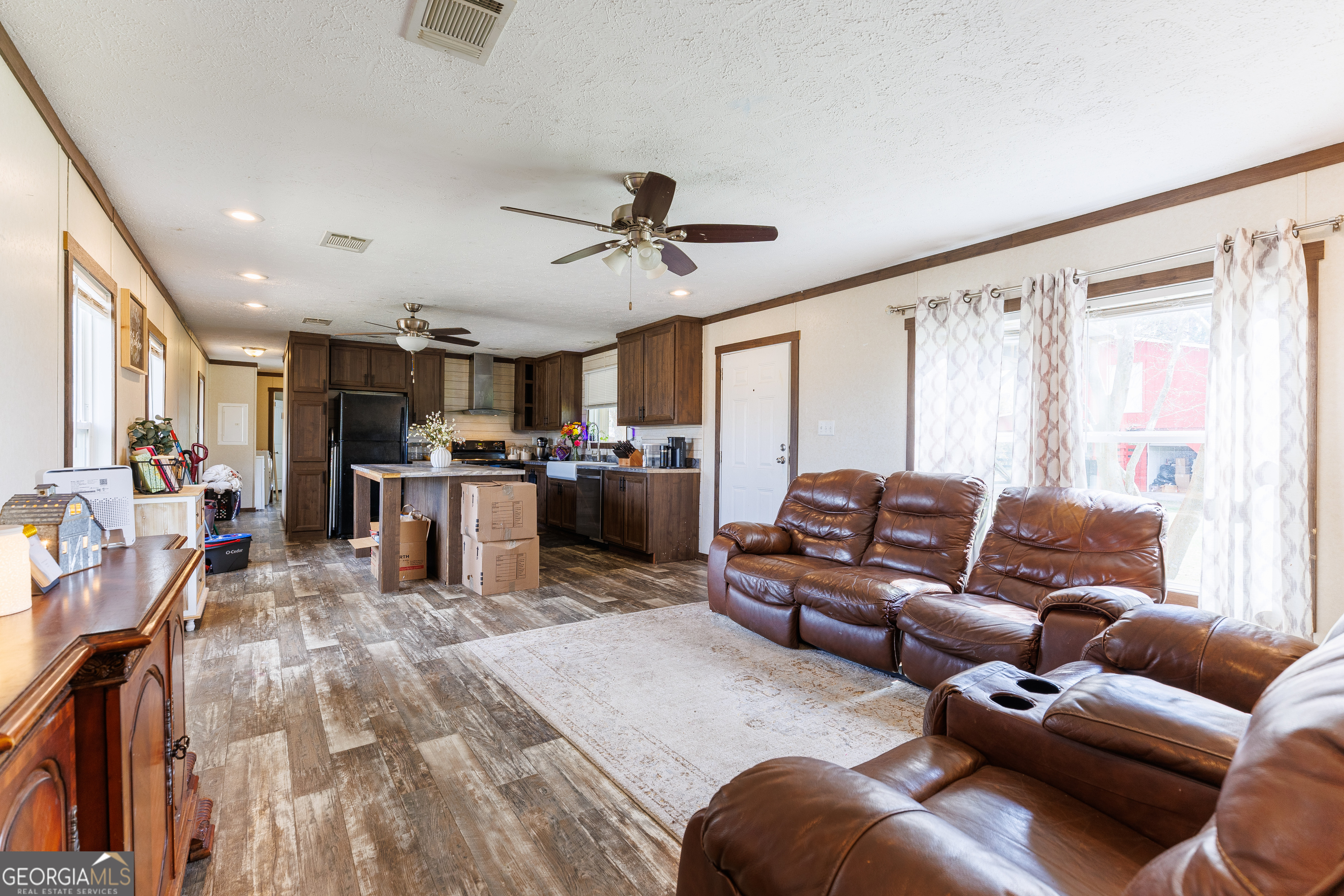1121 Futch Road Adel, GA 31620 - Photo 7 of 28 a living room with furniture kitchen view and a wooden floor