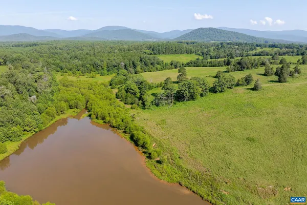 a view of a lush green hillside and houses