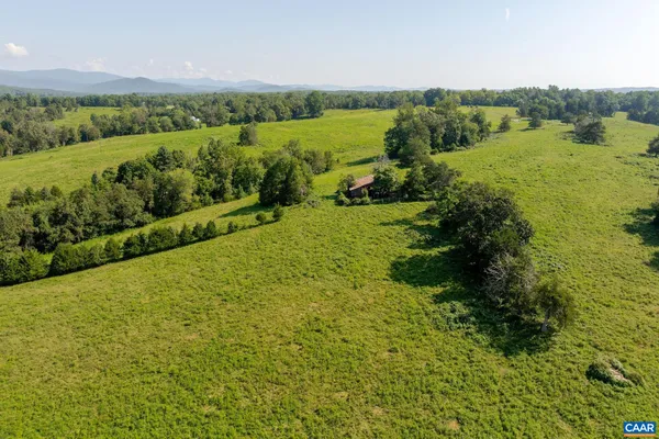 a view of a green field with an ocean view