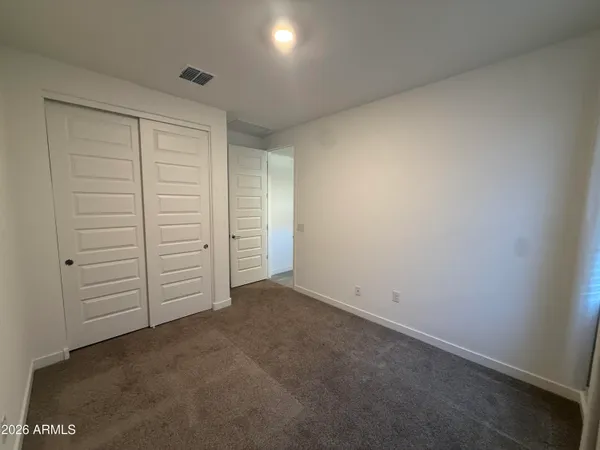 an empty room with closet area