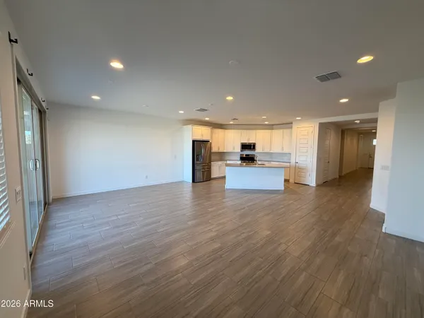 a view of kitchen with a refrigerator a sink and a stove
