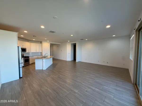 a view of kitchen view wooden floor appliances and kitchen view