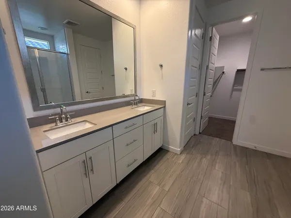 a spacious bathroom with a double vanity sink and a mirror