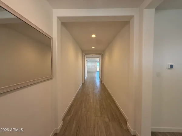 a view of a hallway with wooden floor