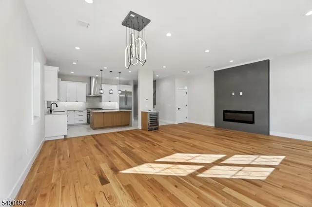 a large kitchen with kitchen island a sink a center island a stove and a window