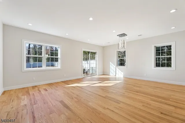 a kitchen with stainless steel appliances kitchen island granite countertop a refrigerator and a sink
