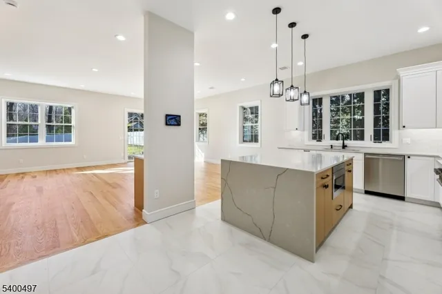 a view of a hallway with wooden floor and entryway