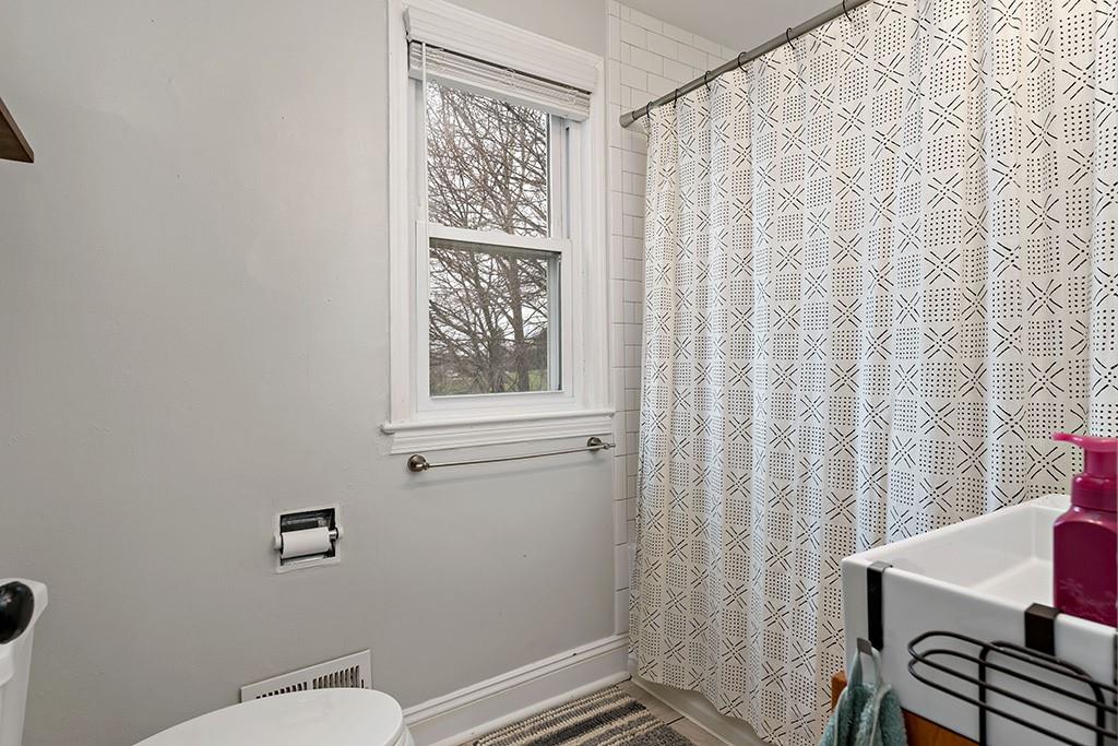 231 Scott Road Pittsburgh, PA 15239 - Photo 19 of 30 a bathroom with a toilet and a shower curtain