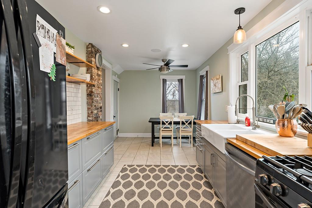 231 Scott Road Pittsburgh, PA 15239 - Photo 9 of 30 a large kitchen with a table and chairs