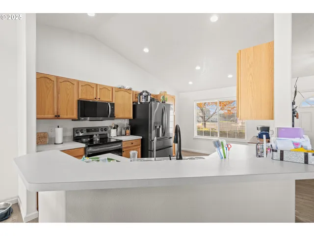 a kitchen with a sink a counter appliances and cabinets