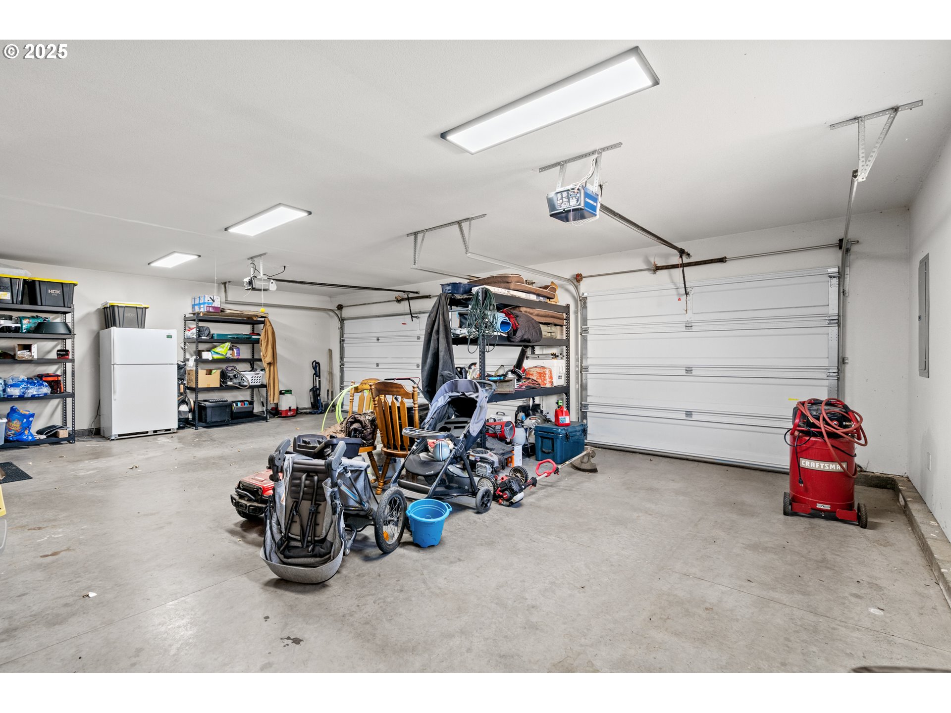 620 West Wren Avenue Hermiston, OR 97838 - Photo 30 of 48 a view of a garage with a bike and white walls
