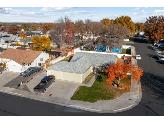 an aerial view of residential building and car parked