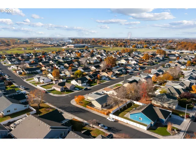 an aerial view of residential houses with outdoor space