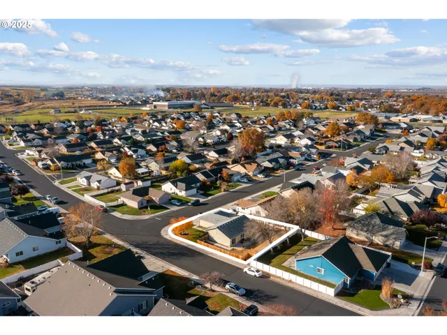 an aerial view of residential houses with outdoor space