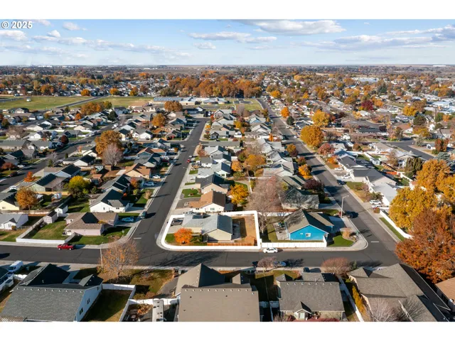 an aerial view of a house with a swimming pool