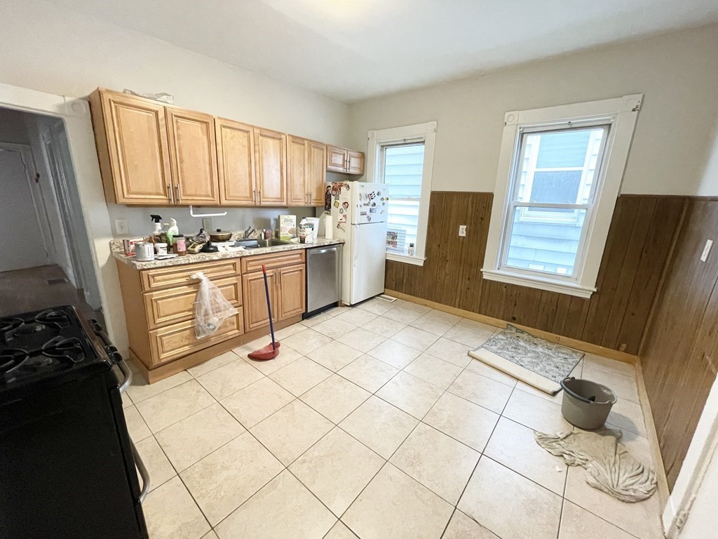 10 Wave Avenue, Unit 1 Boston, MA 02125 - Photo 2 of 9 a kitchen with stainless steel appliances a stove a sink and a refrigerator