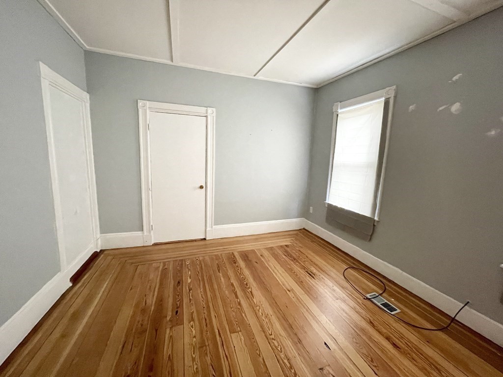10 Wave Avenue, Unit 1 Boston, MA 02125 - Photo 4 of 9 a view of a room with wooden floor and window
