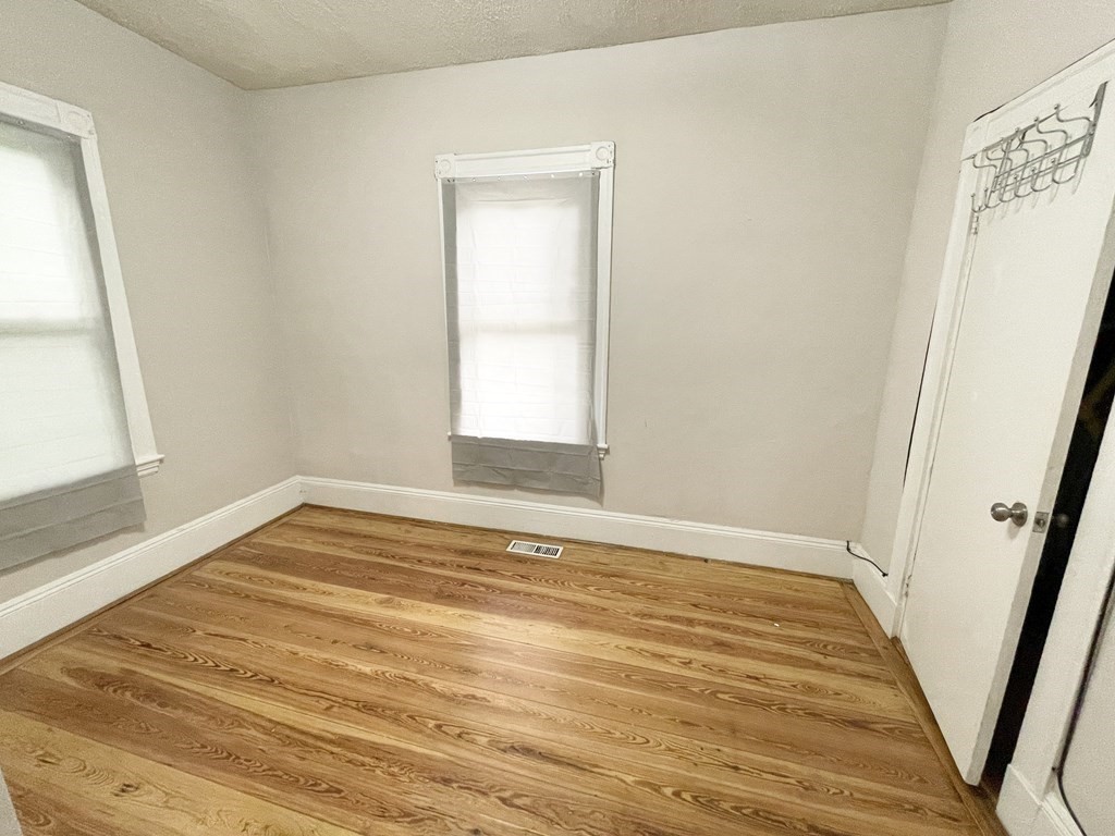 10 Wave Avenue, Unit 1 Boston, MA 02125 - Photo 6 of 9 a view of an empty room and wooden floor