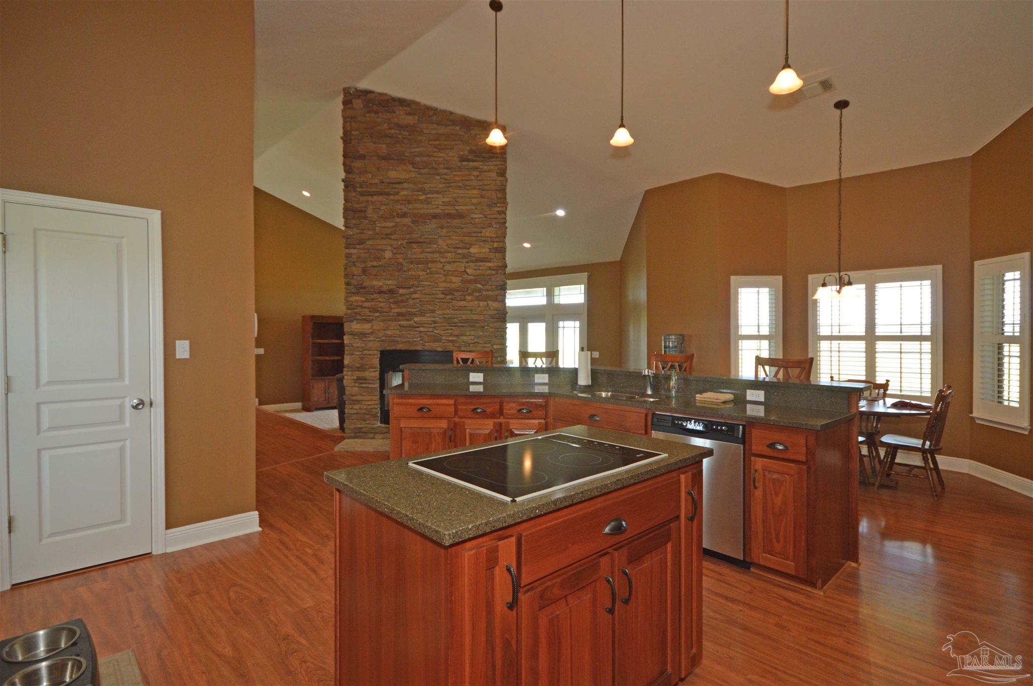 3478 Pine Level Church Road Jay, FL 32565 - Photo 18 of 50 a kitchen with stainless steel appliances granite countertop a sink a stove and a wooden floor