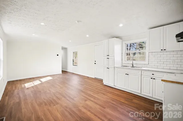 a view of a kitchen with wooden floor