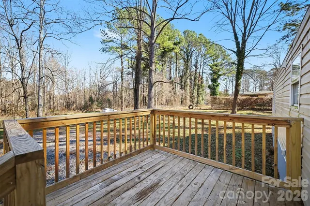 a view of wooden balcony with a trees