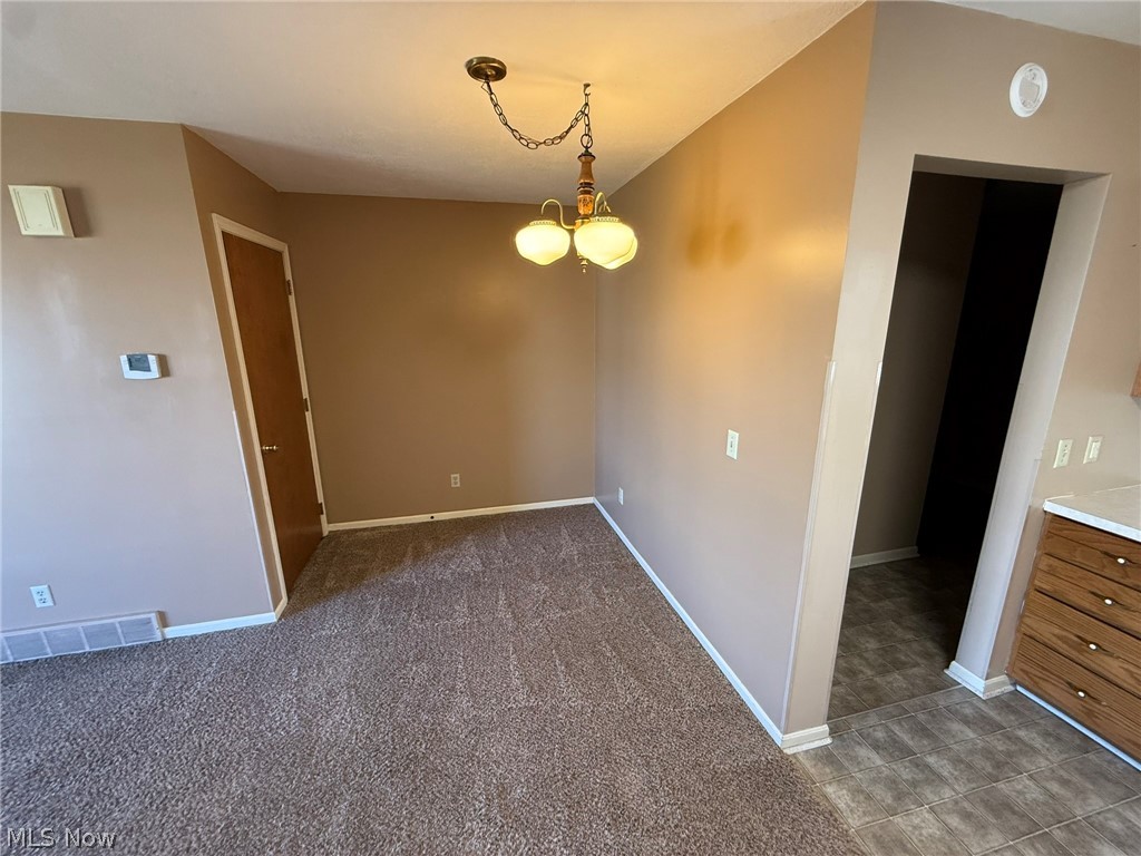 604 Harger Street Dover, OH 44622 - Photo 6 of 25 Unfurnished dining area with light carpet and baseboards