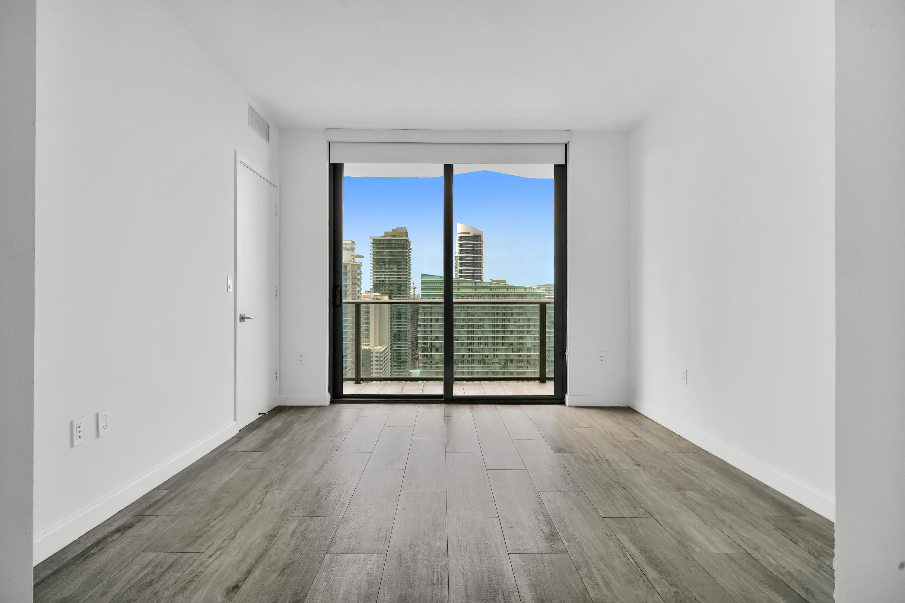 55 Southwest 9th Street, Unit 3504 Miami, FL 33130 - Photo 12 of 33 a view of a room with wooden floor and a window