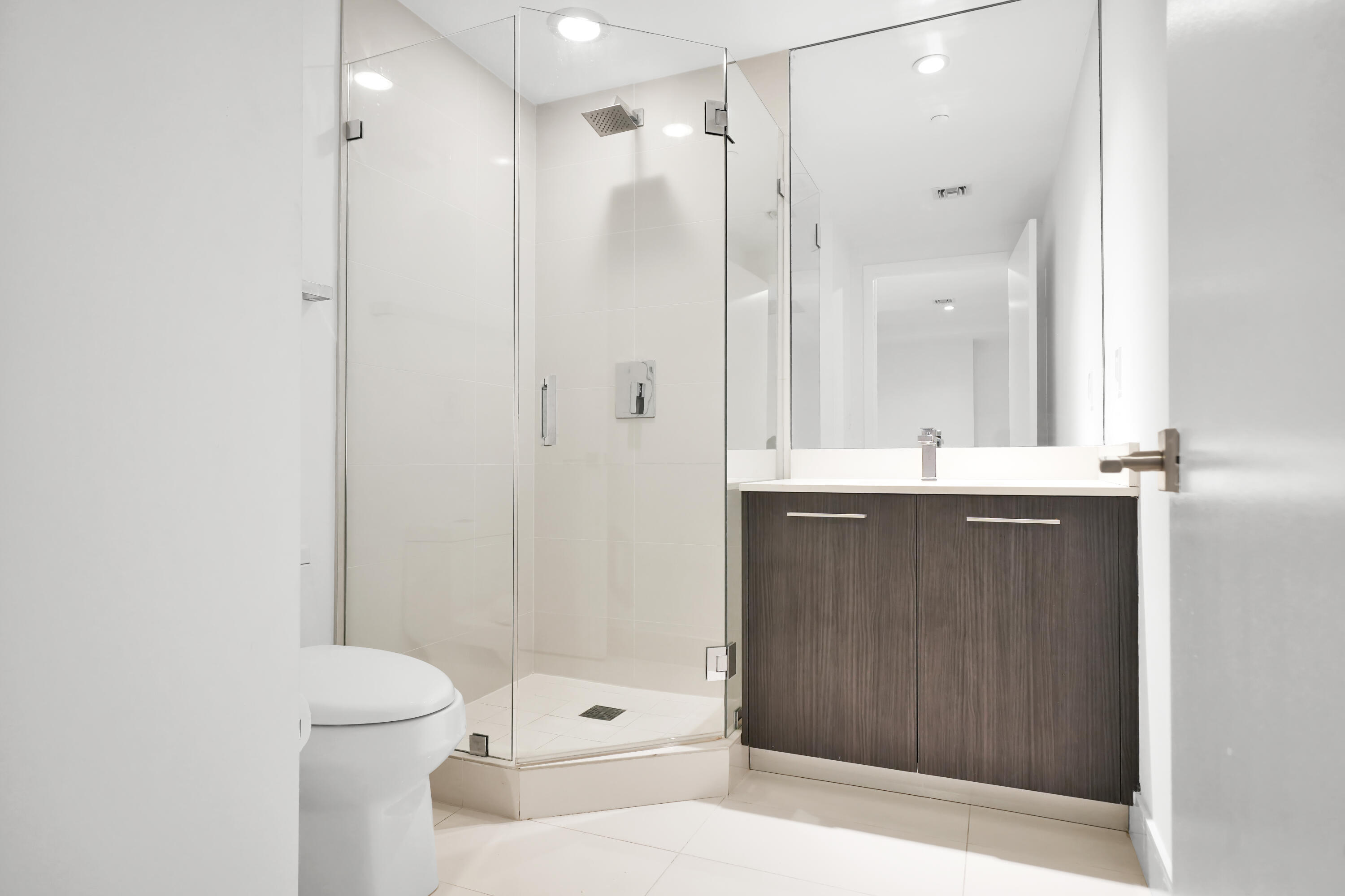 55 Southwest 9th Street, Unit 3504 Miami, FL 33130 - Photo 5 of 33 a bathroom with a sink and a mirror