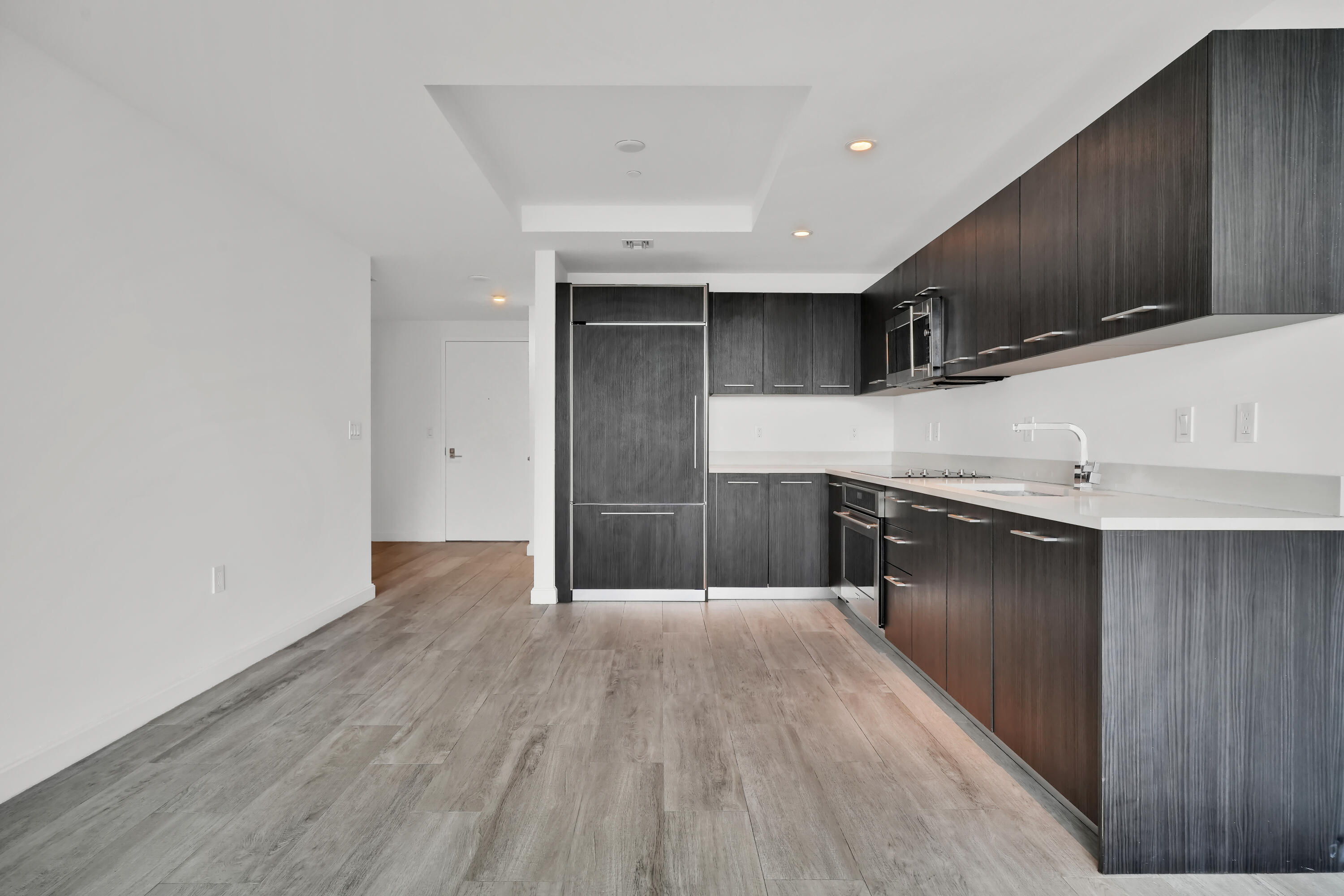 55 Southwest 9th Street, Unit 3504 Miami, FL 33130 - Photo 7 of 33 a kitchen with a wooden floor and a sink