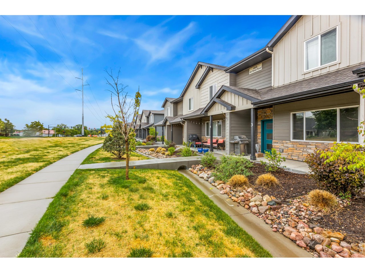 6609 4th St Road, Unit 4 Greeley, CO 80634 - Photo 5 of 41 a view of a house with swimming pool and a chairs
