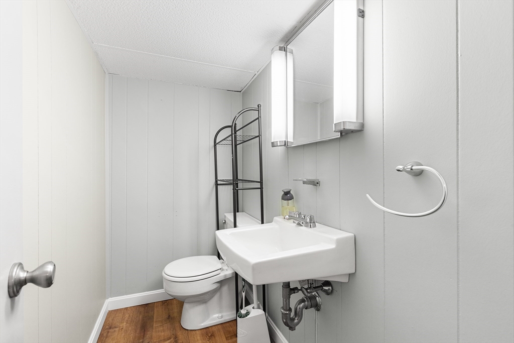 10 Livoli Road Framingham, MA 01701 - Photo 25 of 36 a bathroom with a sink a toilet and mirror