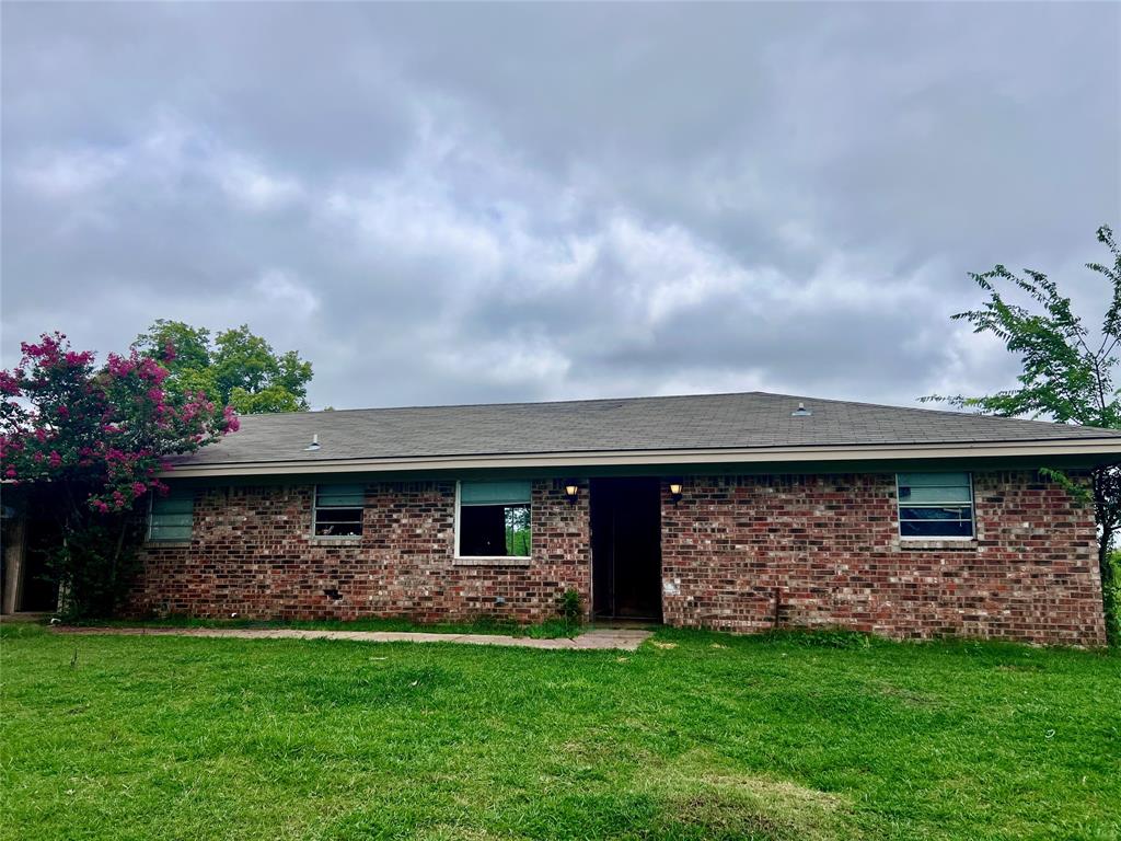 5193 County Road Blossom, TX 75416 - Photo 2 of 15 a front view of a house with a garden