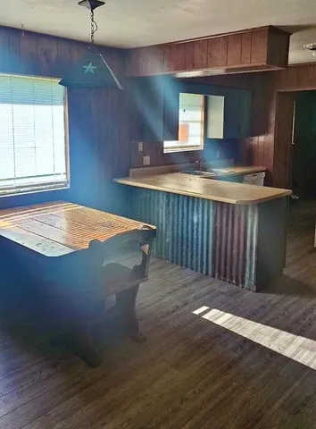 a kitchen with kitchen island a sink appliances and a counter top space