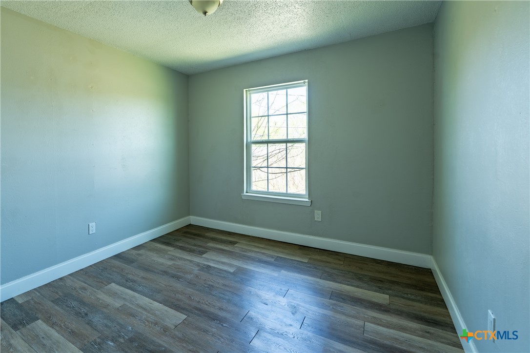 512 Sunset Lane, Unit AD Copperas Cove, TX 76522 - Photo 23 of 23 an empty room with wooden floor and windows