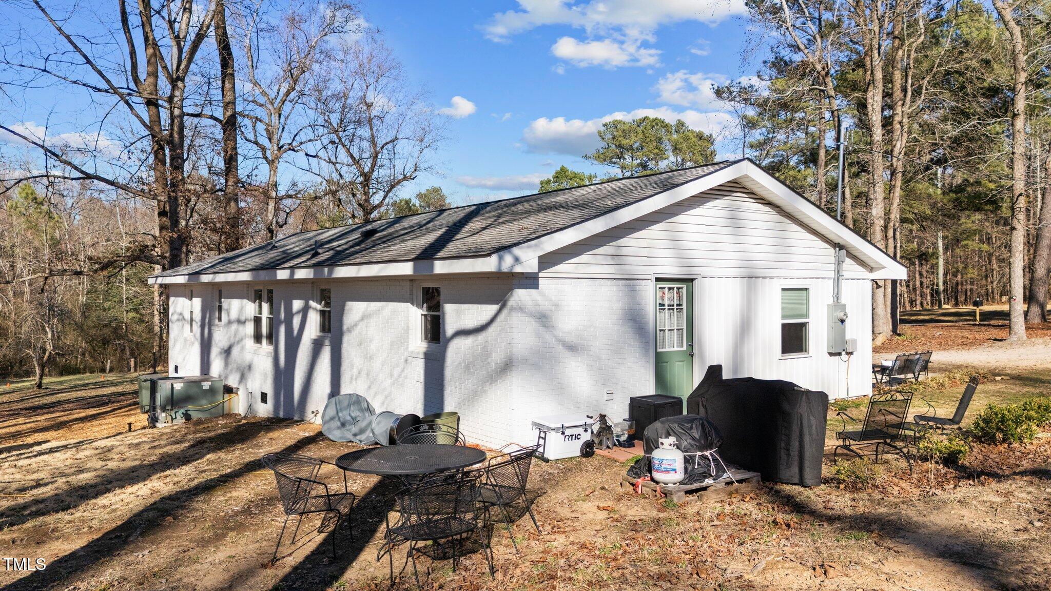 4775 Barber Mill Road Clayton, NC 27520 - Photo 21 of 54 a view of a house with backyard and sitting area