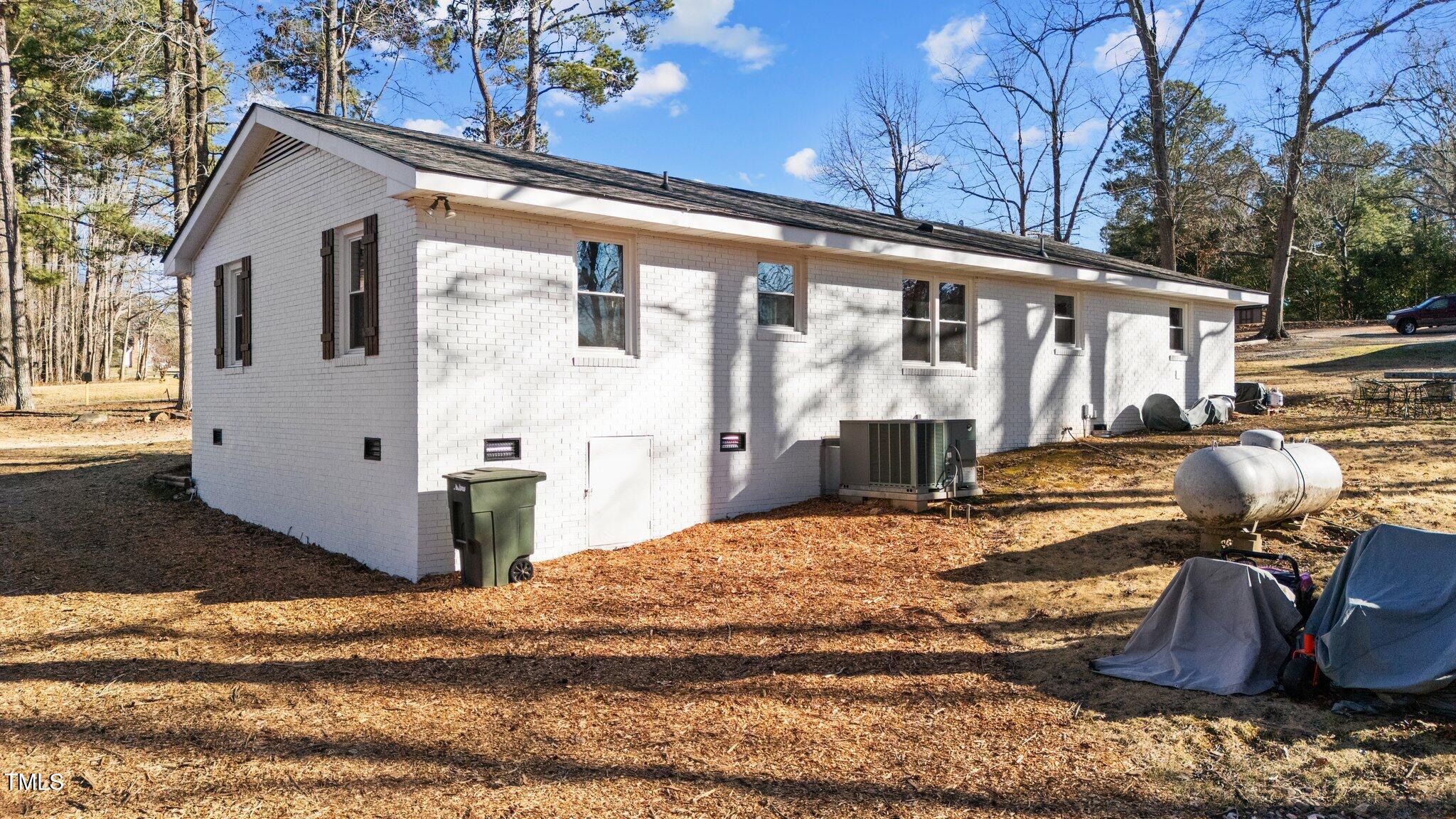 4775 Barber Mill Road Clayton, NC 27520 - Photo 22 of 54 a view of a house with backyard and sitting area