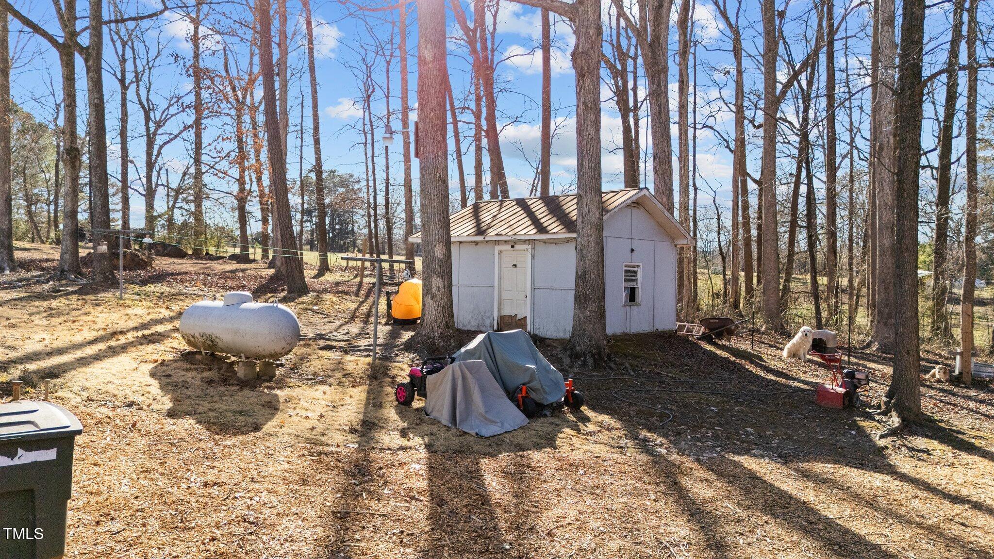 4775 Barber Mill Road Clayton, NC 27520 - Photo 23 of 54 a view of a chairs and fire pit in the backyard of house