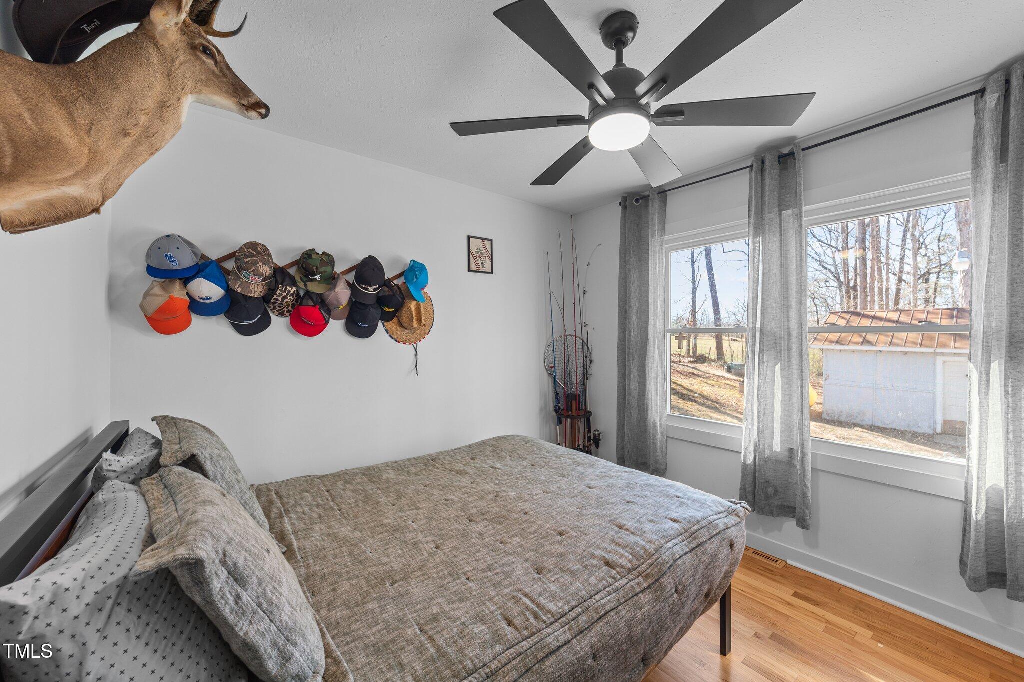 4775 Barber Mill Road Clayton, NC 27520 - Photo 46 of 54 a bedroom with a bed and a large window