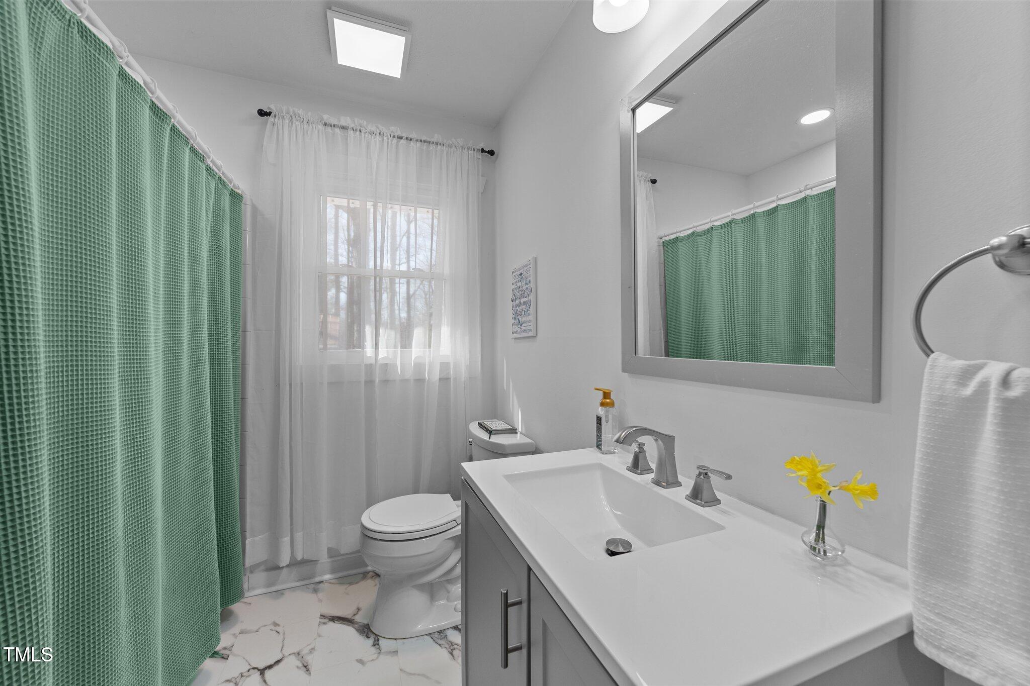 4775 Barber Mill Road Clayton, NC 27520 - Photo 48 of 54 a bathroom with a sink a toilet and shower