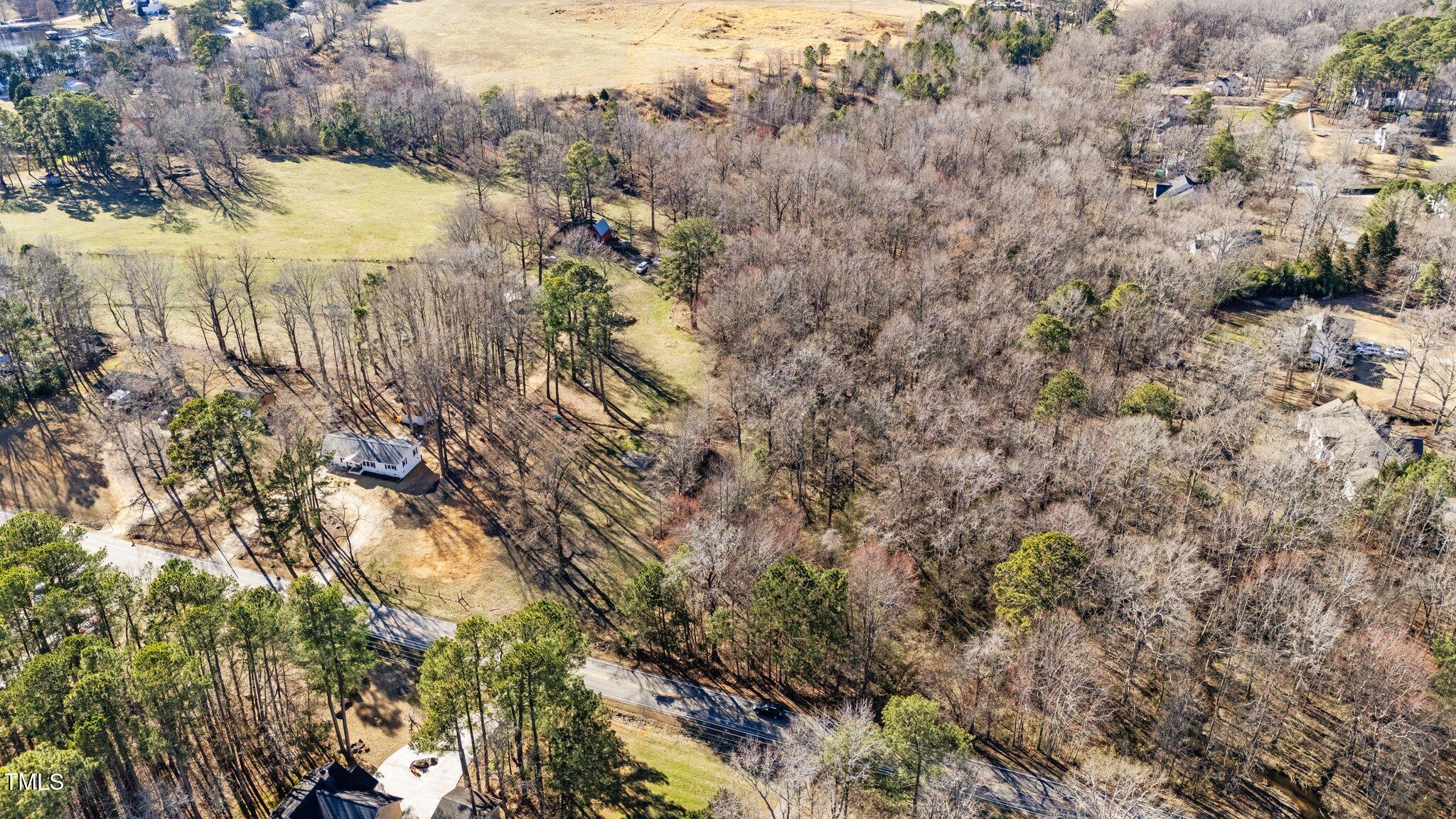 4775 Barber Mill Road Clayton, NC 27520 - Photo 7 of 54 a view of a yard with a tree