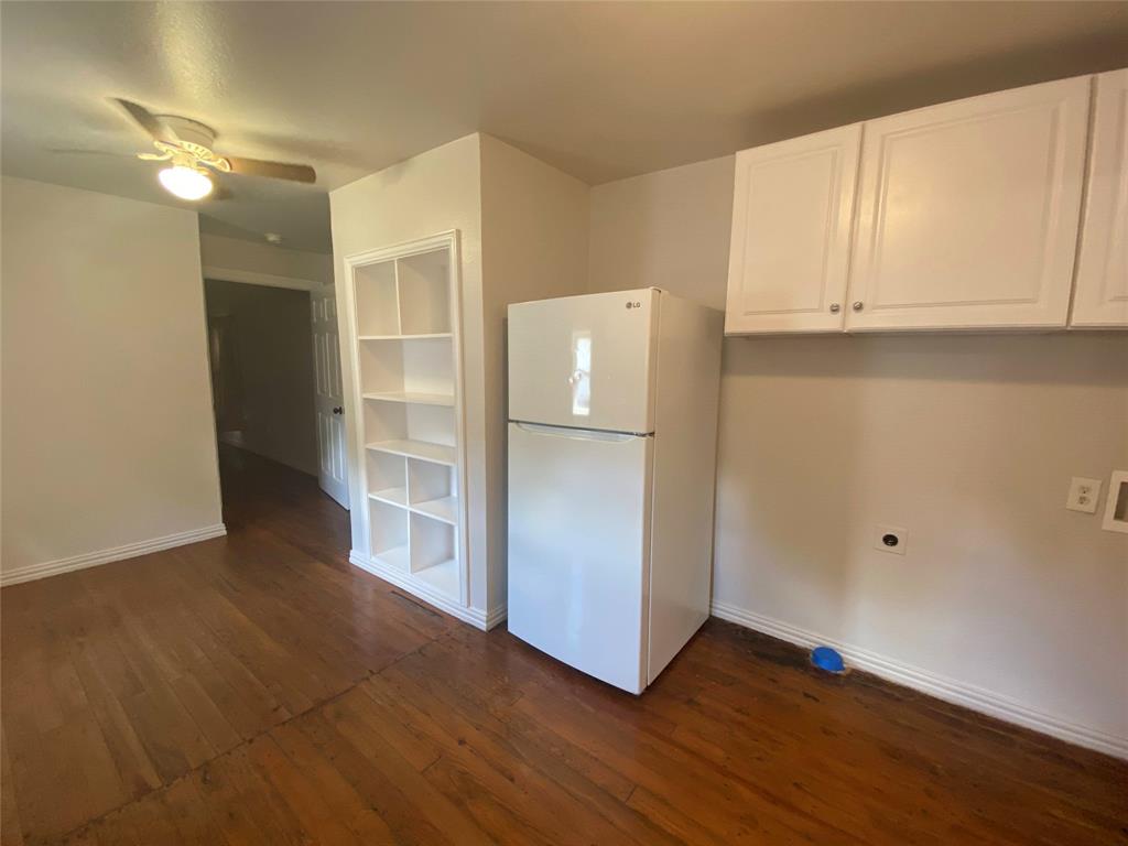 810 Greenville Road McKinney, TX 75069 - Photo 13 of 21 a view of an empty room with wooden floor and cabinet