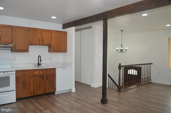 a kitchen with a sink a refrigerator and cabinets