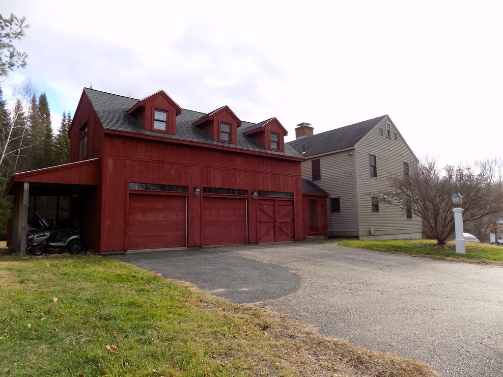 176 Crouch Road Warren, MA 01092 - Photo 2 of 19 a view of a house with a large window and a yard