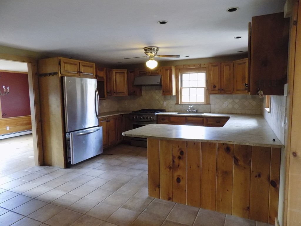 176 Crouch Road Warren, MA 01092 - Photo 3 of 19 a kitchen with kitchen island a counter space and refrigerator